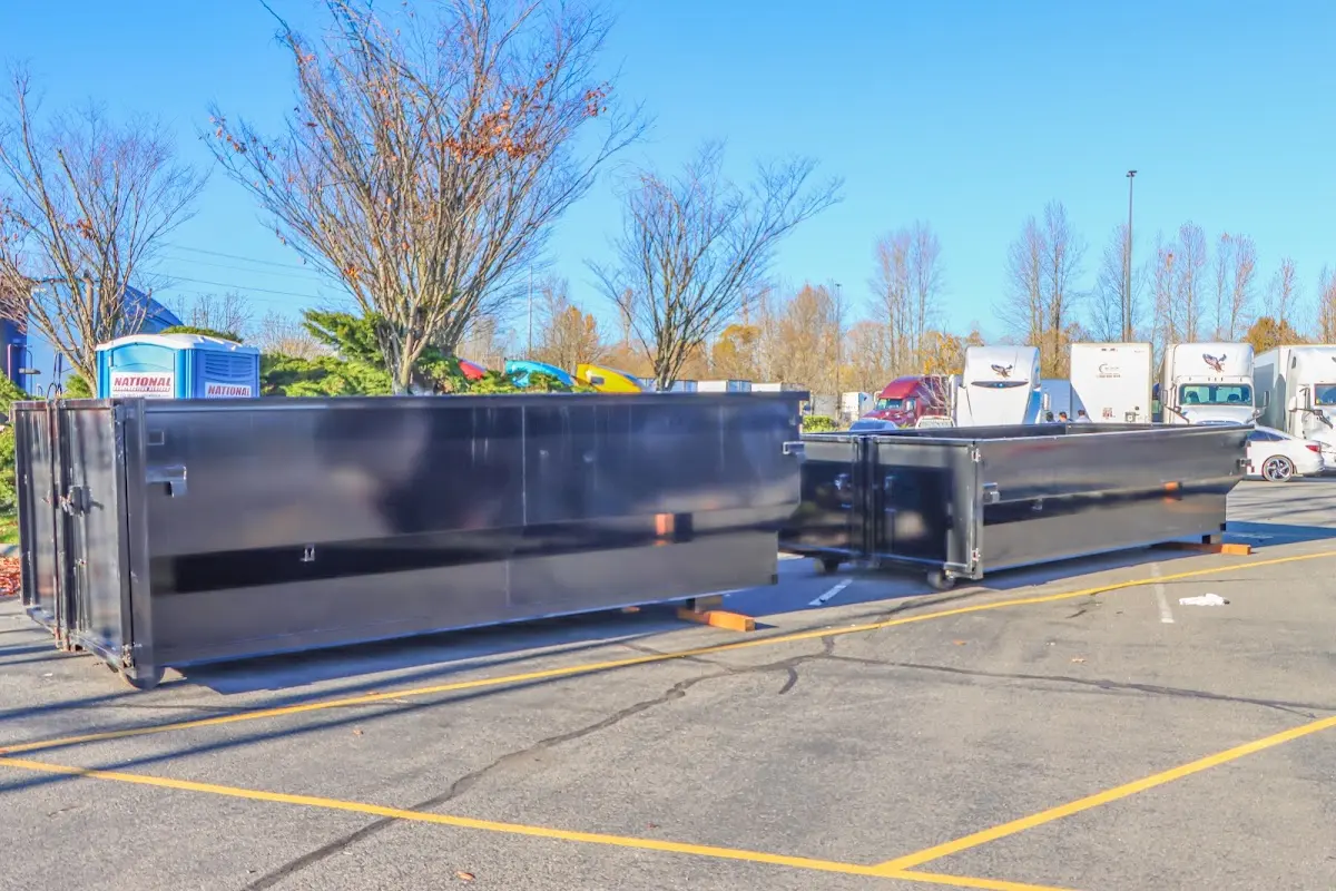 Professional dumpster rental service with roll-off container on residential driveway in Casas Adobes